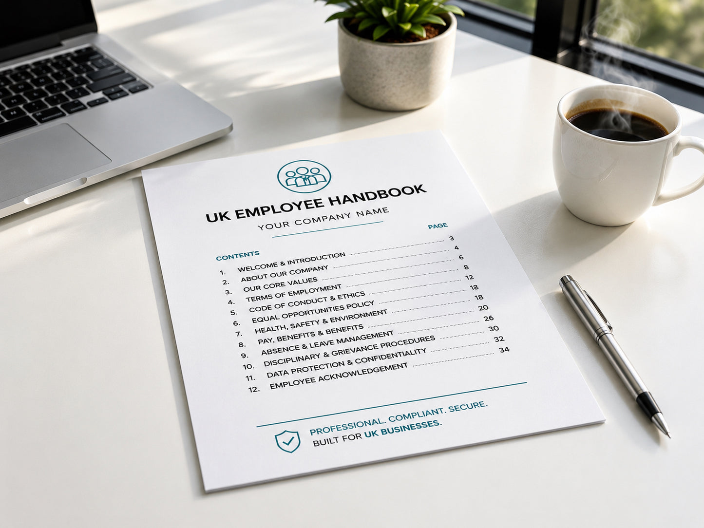 UK Employee Handbook on a desk with a laptop, coffee, and plant — HR Launch Box